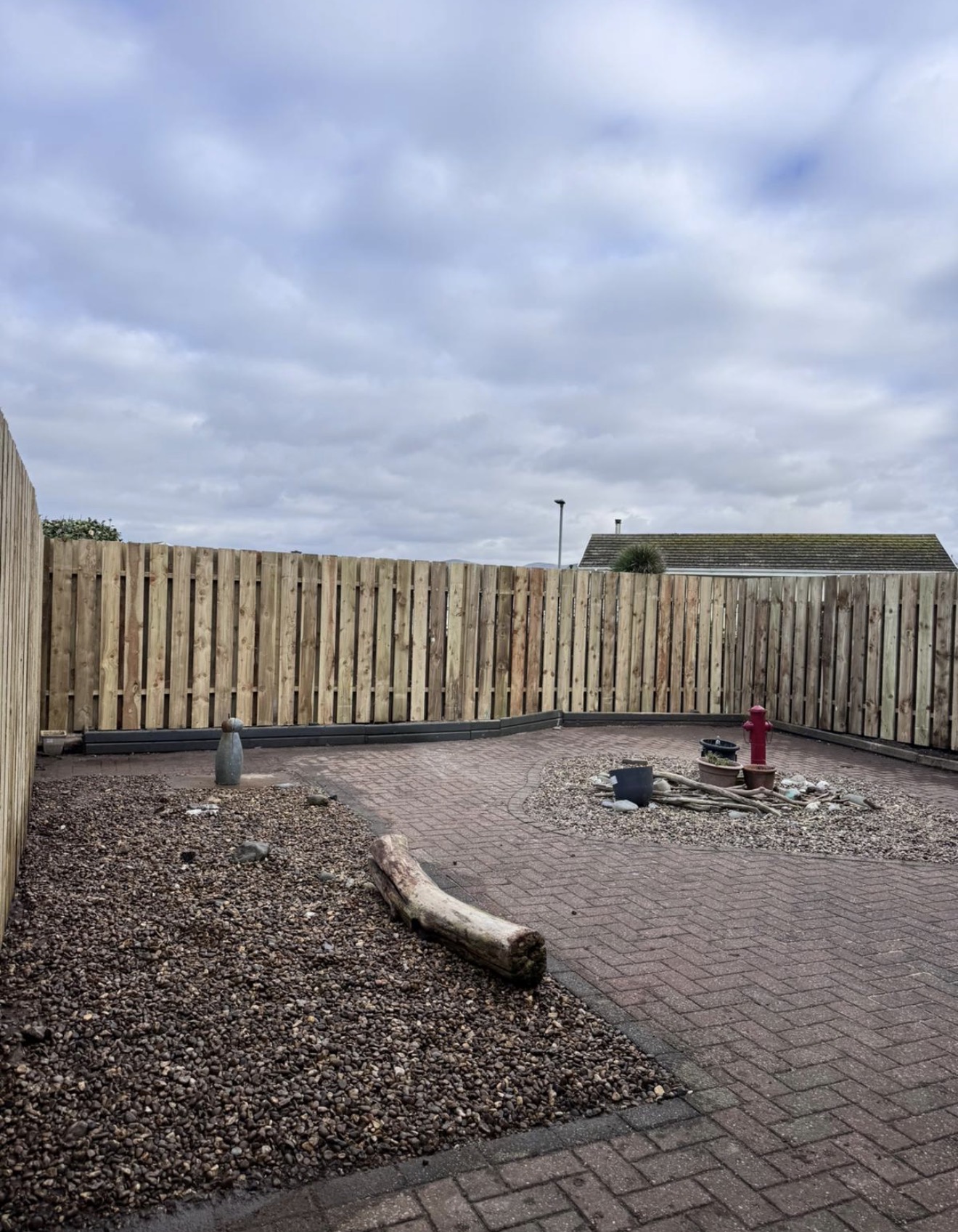 Garden boundary after clearance with opened-up view and tidier edges